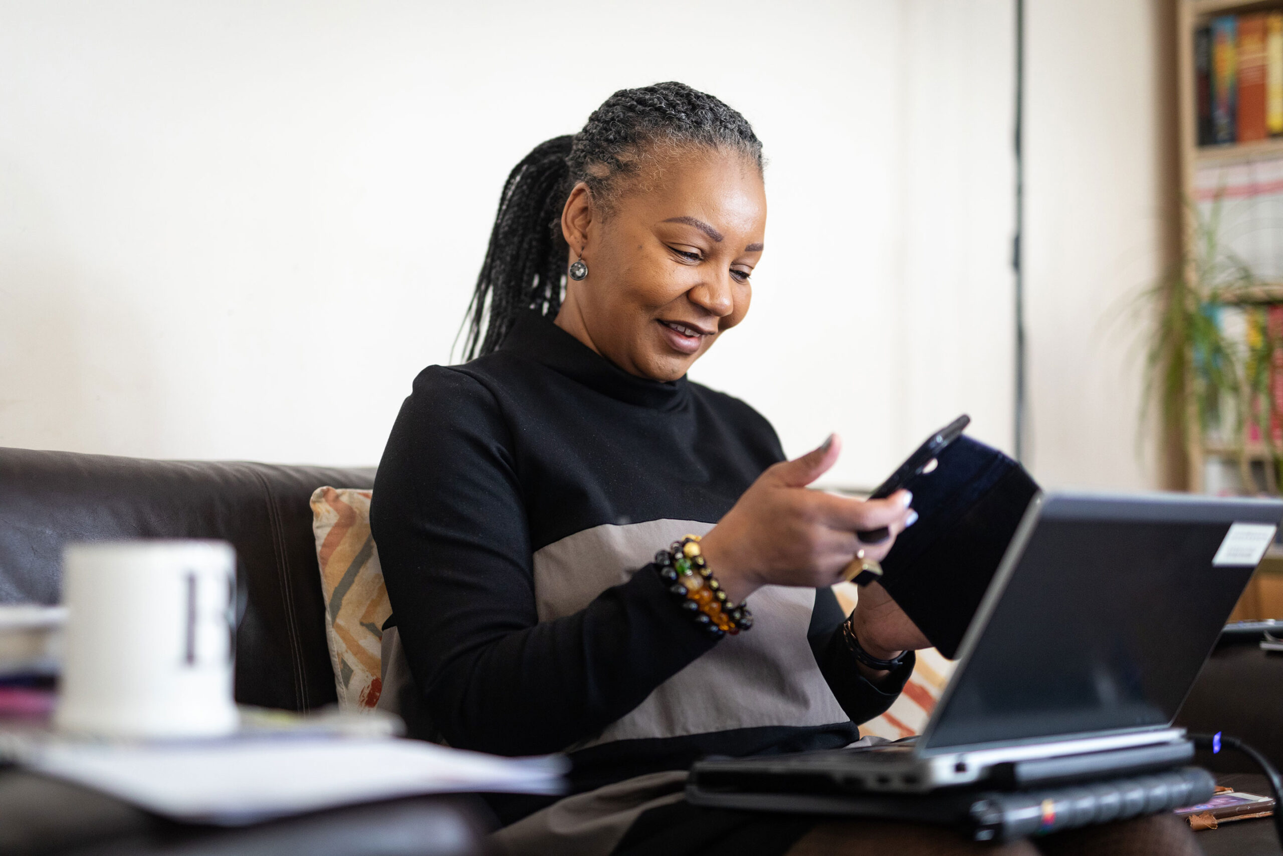 Black woman looking at mobile phone